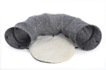 A playful tabby cat excitedly explores a Lulu's World Tunnel with Cushion Mat. The cat peeks out from the crinkly fabric tunnel, batting at a dangling toy mouse. The tunnel is spacious and comfortable, with a soft plush cushion mat inside.